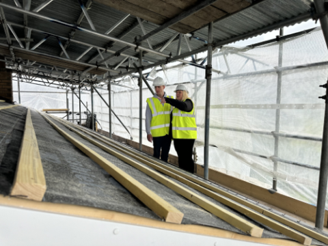 2 builders discussing planning permission for a house extension in Nottingham