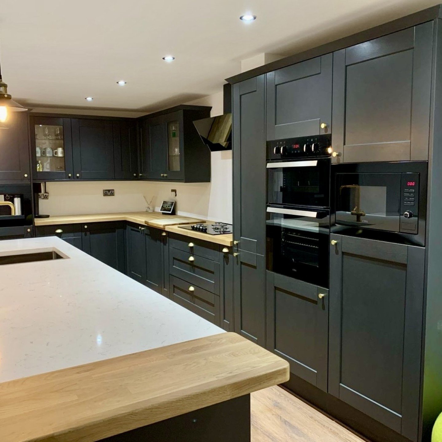Modern kitchen with dark cabinetry, warm wood accents, and inviting open layout.