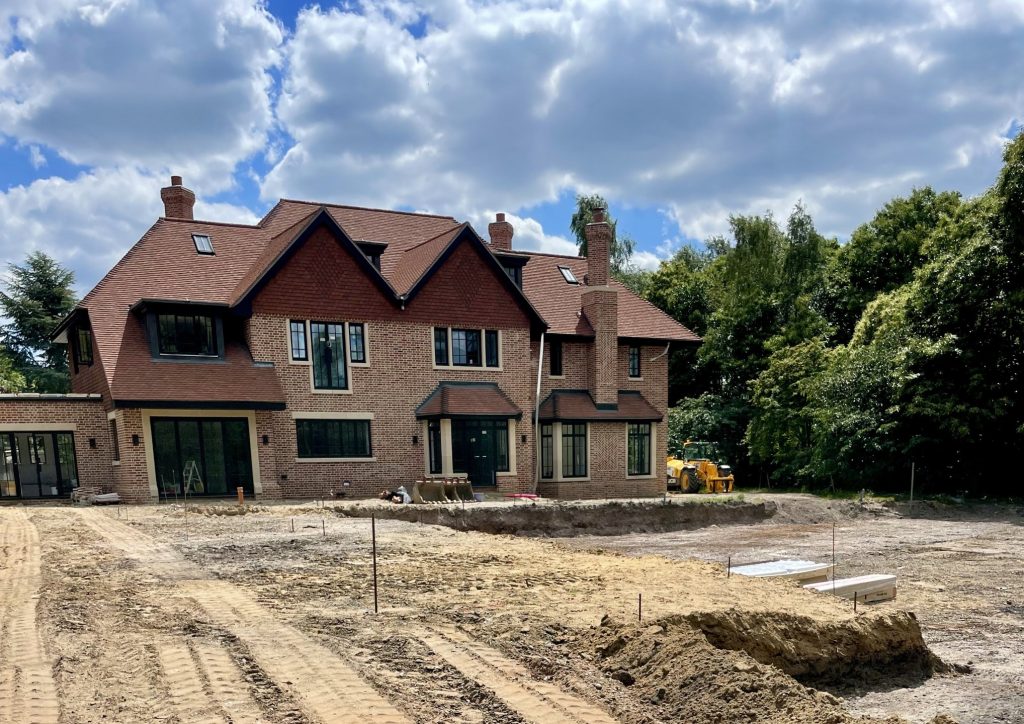 Elegant new home under construction, blending modern and traditional design elements amidst natural surroundings.