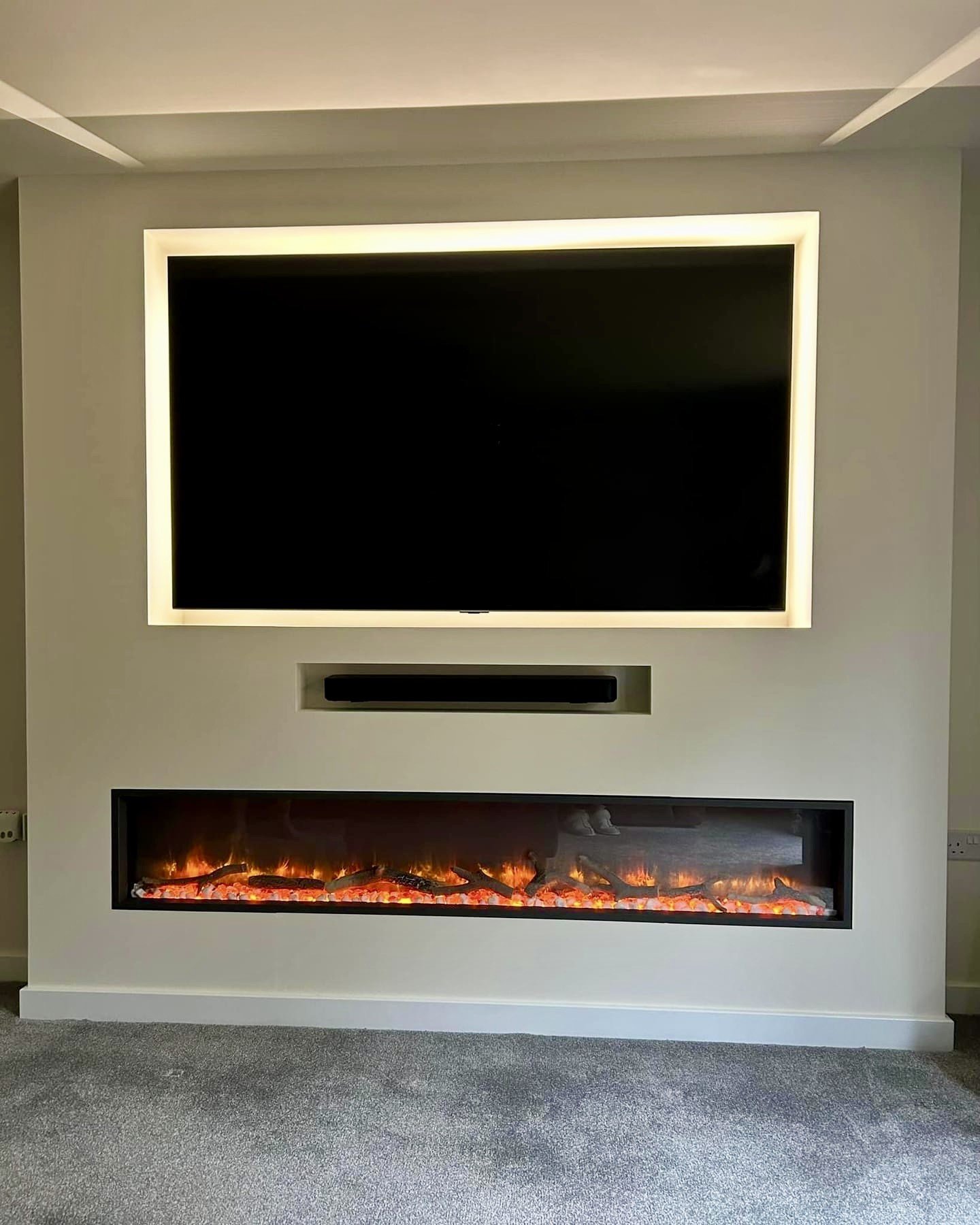 Modern living room with flat-screen TV and electric fireplace, featuring minimalist design.