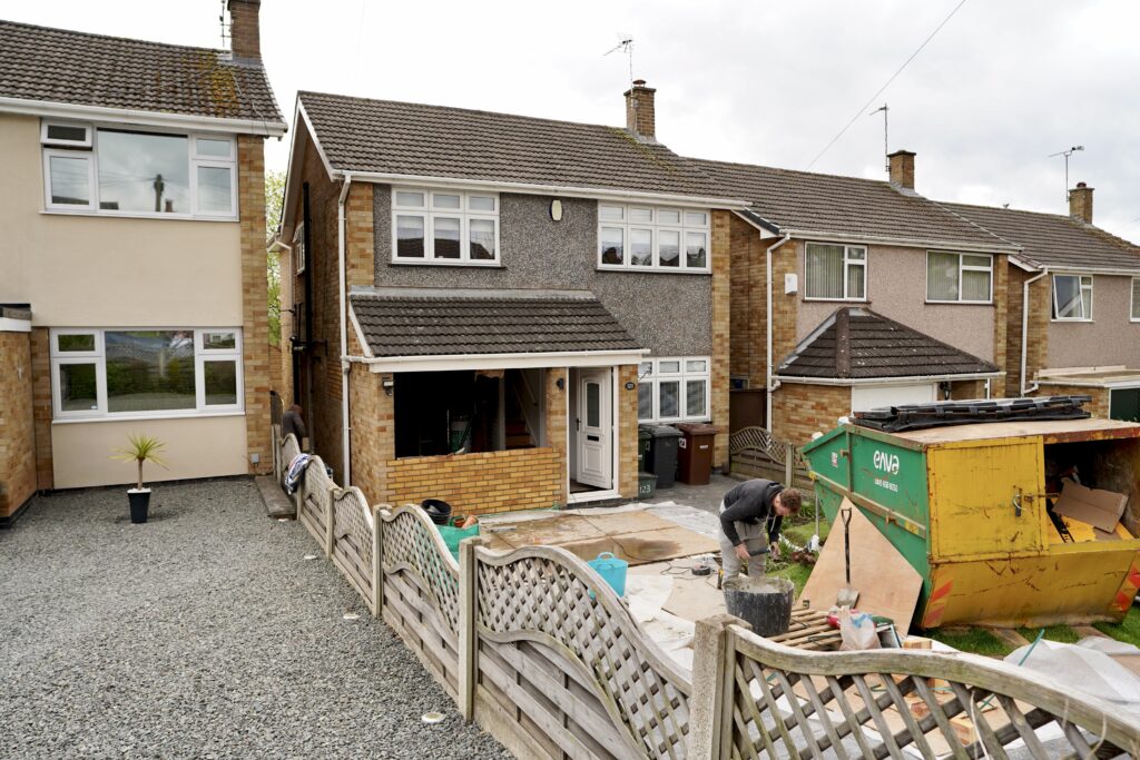 External view of a completed garage conversion on a semi-detached brick property in Nottingham. The original garage door has been replaced with a new entrance door and canopy, creating additional living space. Project completed by Haus Developer, specialists in garage conversions and home extensions across Nottingham and the East Midlands.